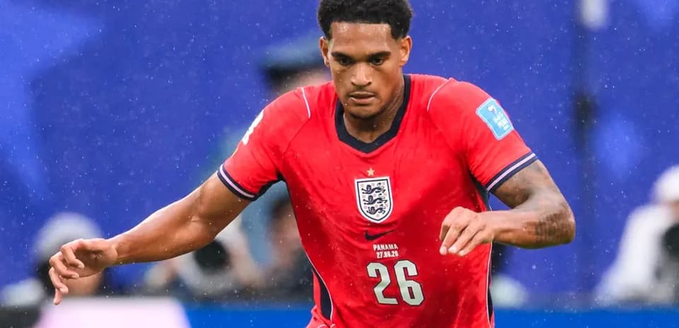 Player in red England jersey running on field