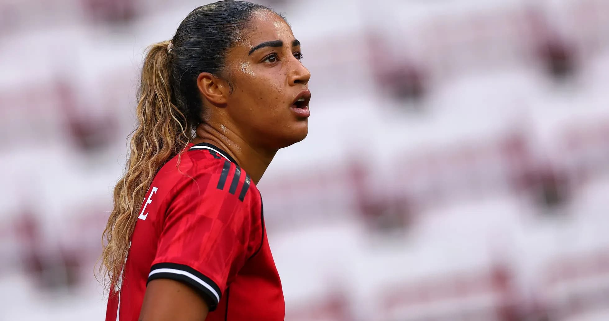Female player in red jersey during match