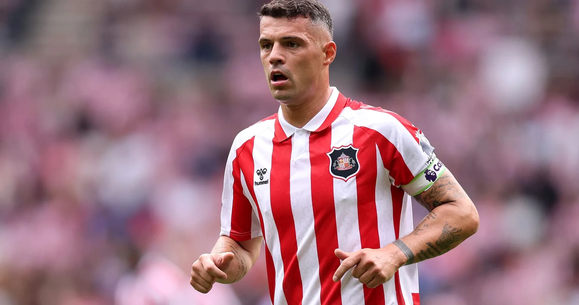 Player in red and white striped jersey on field