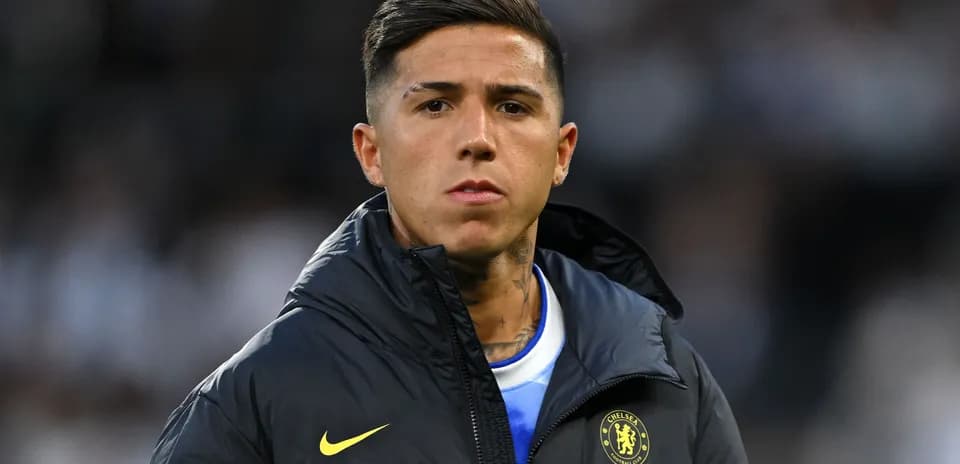 Player wearing Chelsea jacket on the sidelines