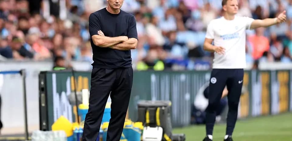 Two coaches on the sidelines during match