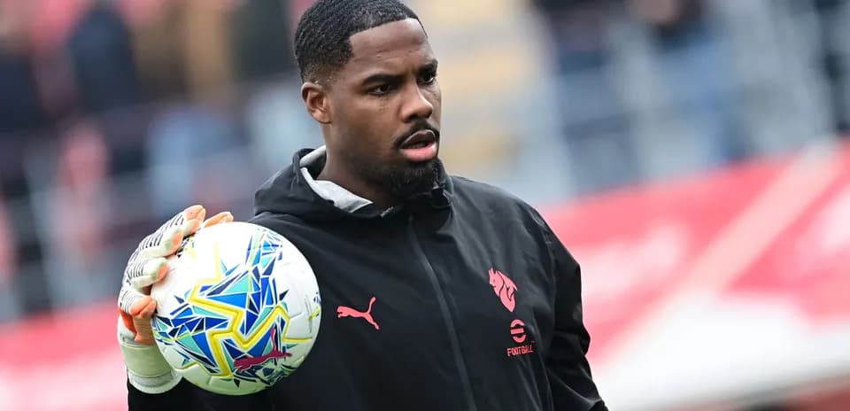 Goalkeeper holding a ball during warm-up