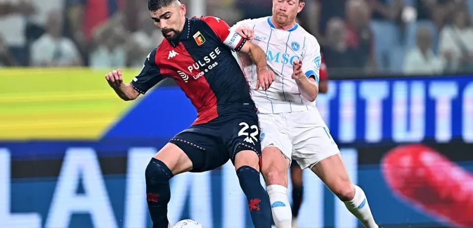 Genoa player challenged by Napoli opponent during match