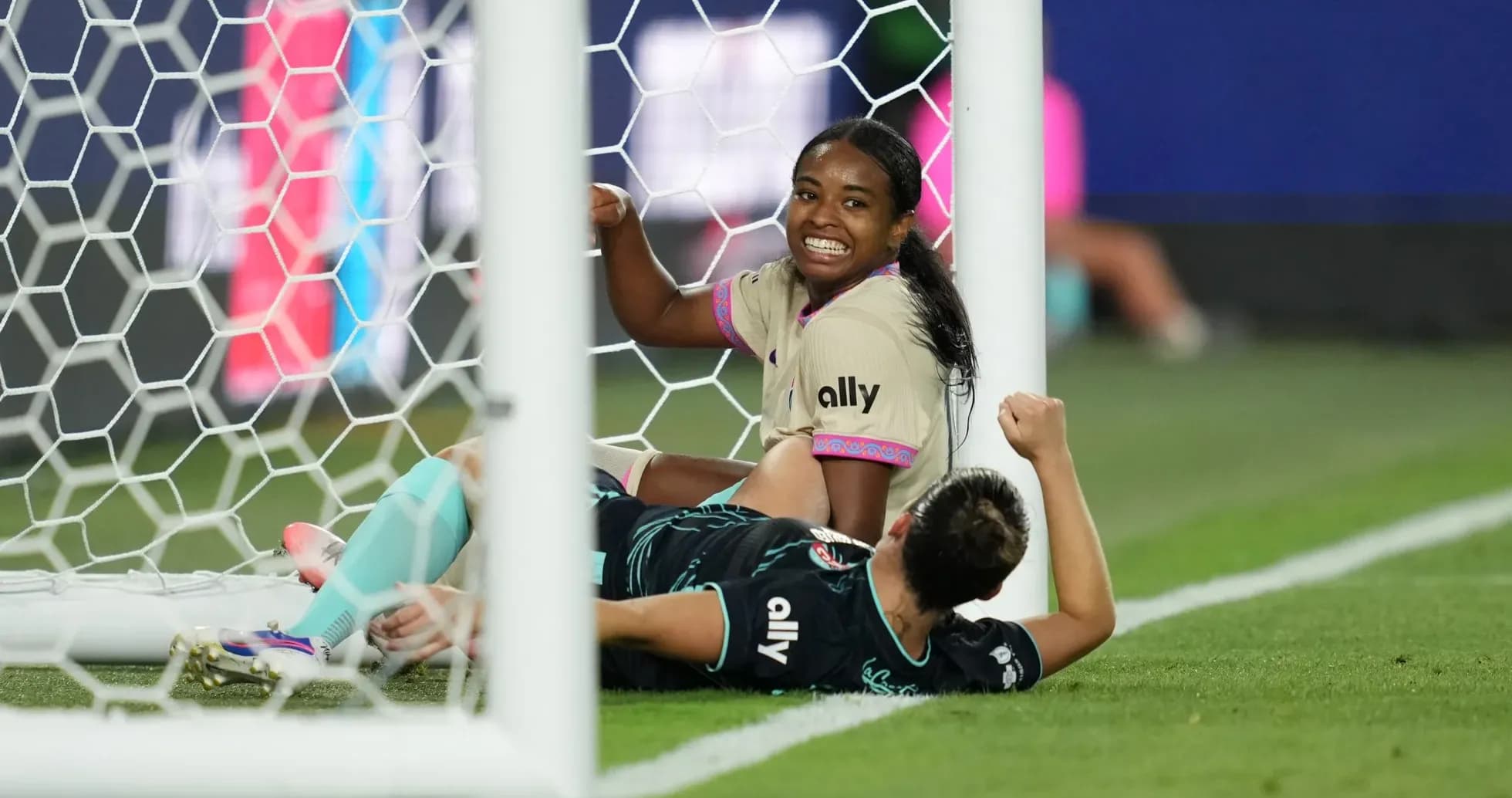 Players celebrating near the goal during match