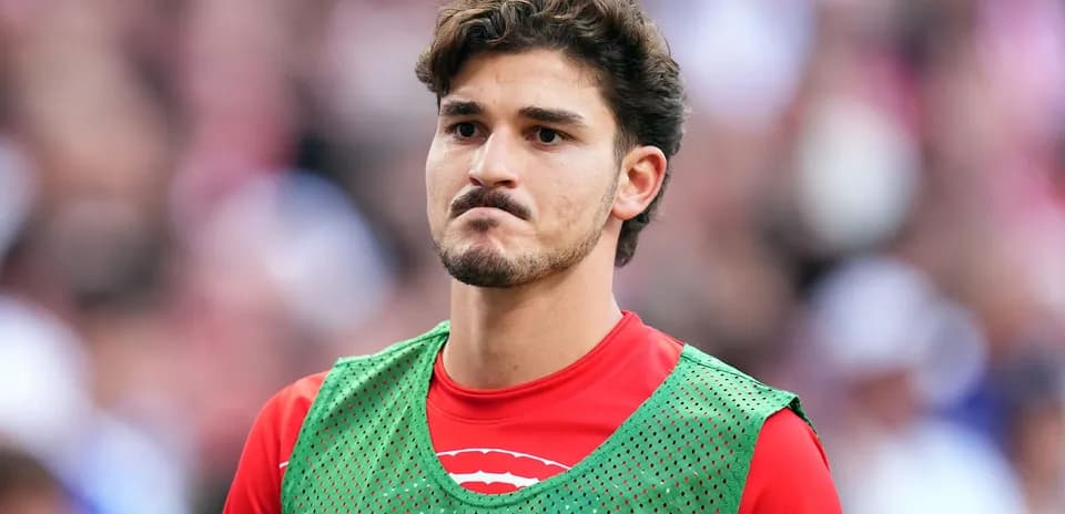 Player wearing training bib on sidelines during match