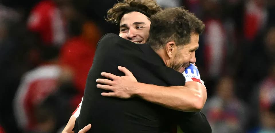 Players celebrating with a hug after victory