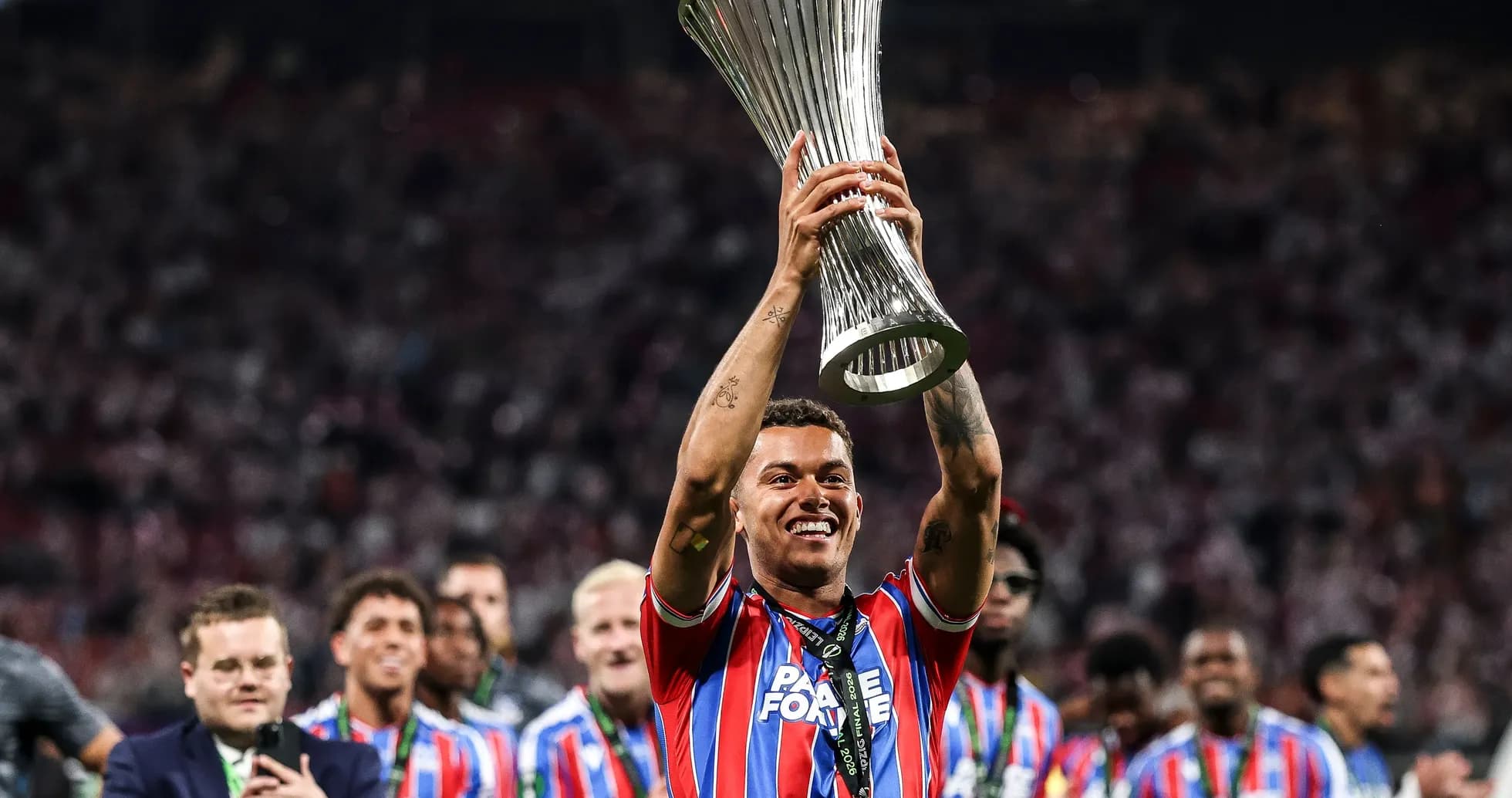 Player celebrating with trophy after winning final