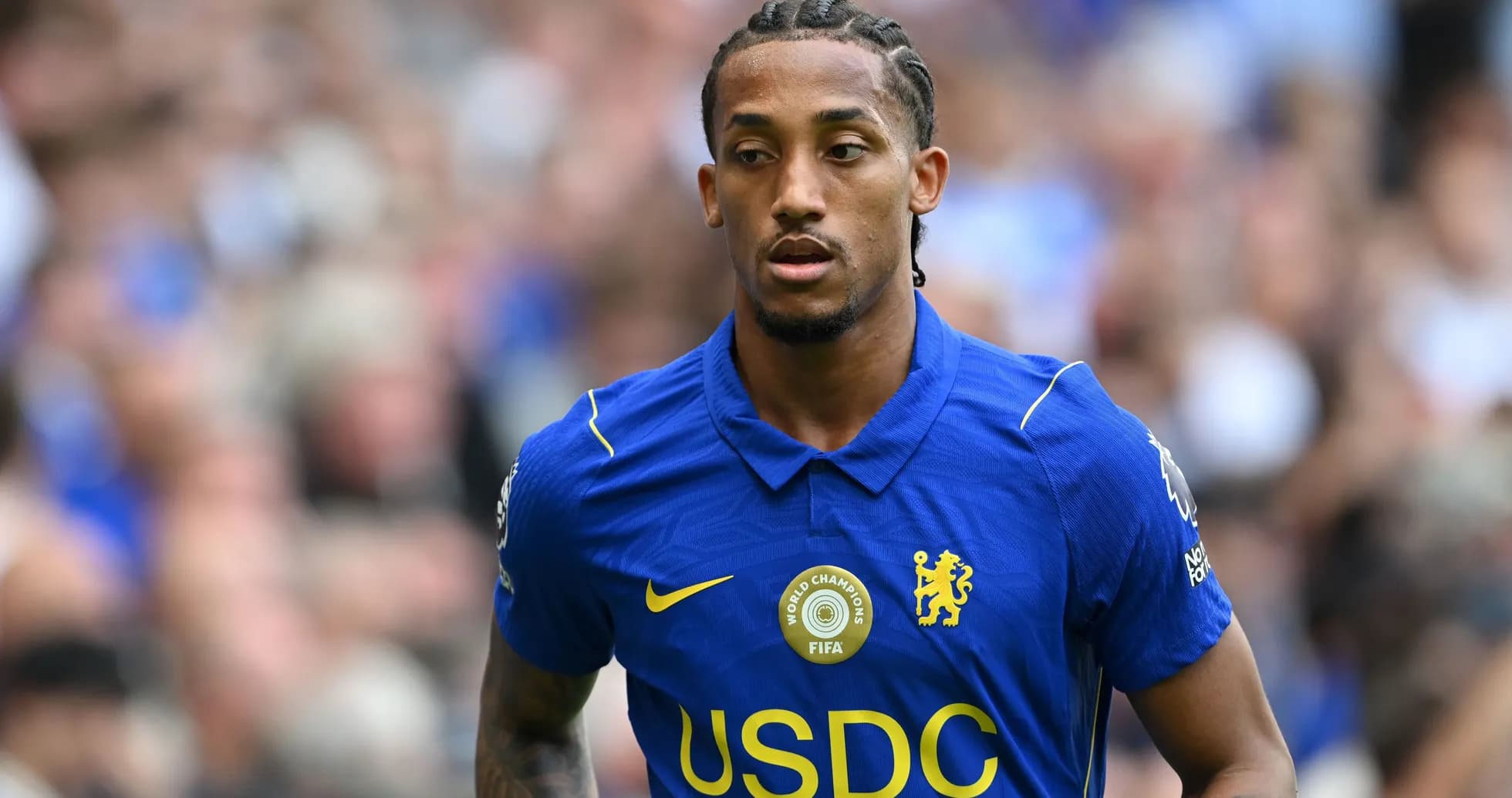 Player wearing blue Chelsea jersey on the field