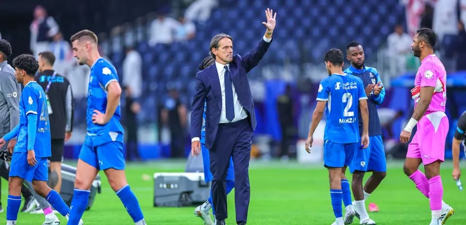 Coach waving as players leave the pitch after match