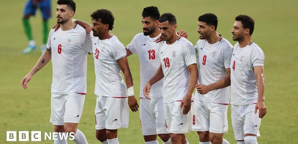Iranian football players walking together on field