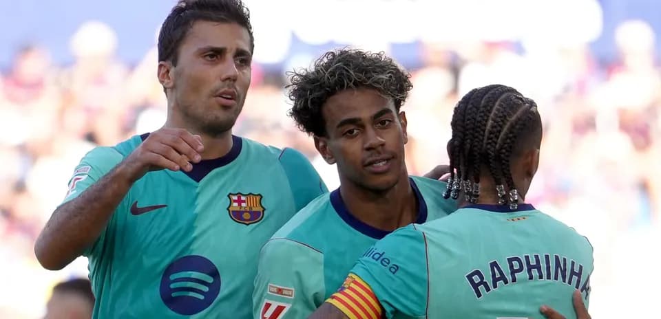 Barcelona players celebrating a goal together on field