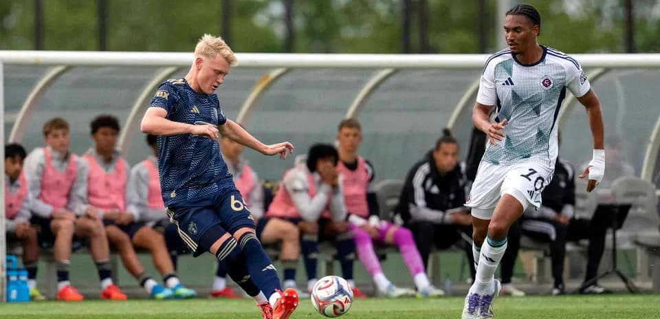 New England II player dribbling the ball