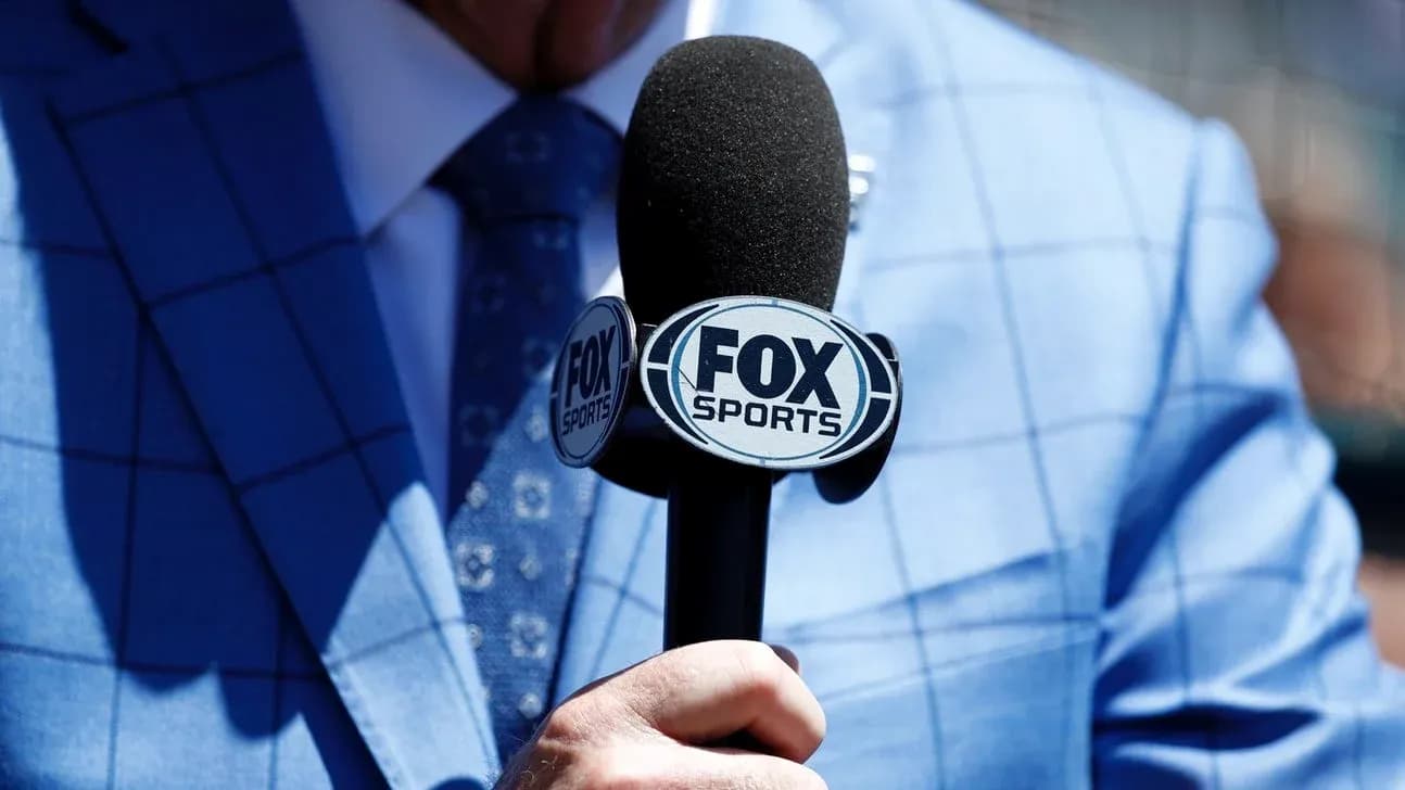 Person holding a microphone with FOX Sports logo