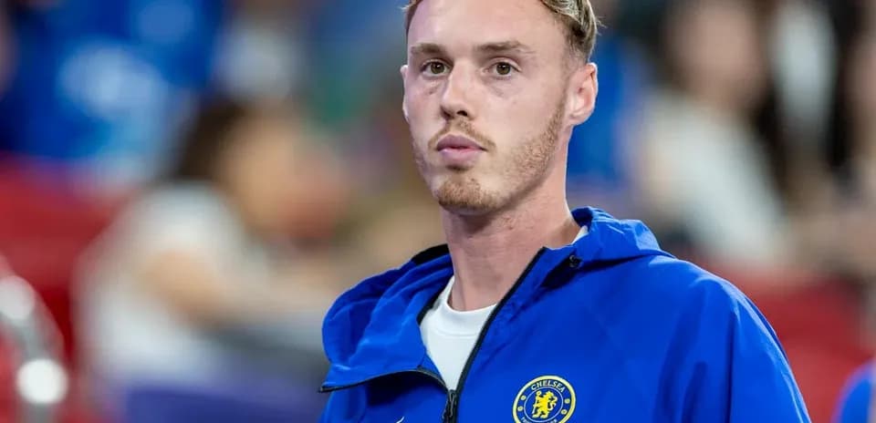 Player in Chelsea jacket during match warm-up