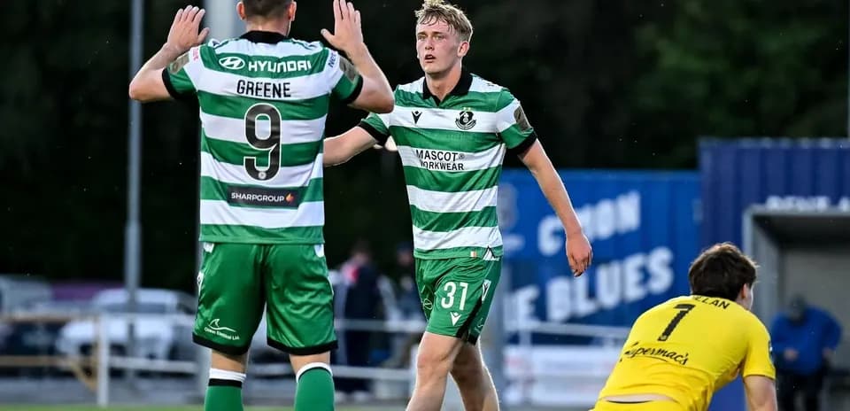 Two players celebrating a goal on the pitch