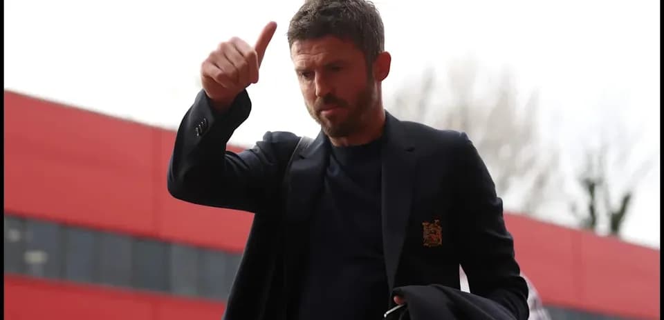 Man giving a thumbs-up gesture outside stadium