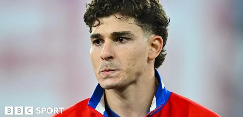 Player in red jersey looking serious on field