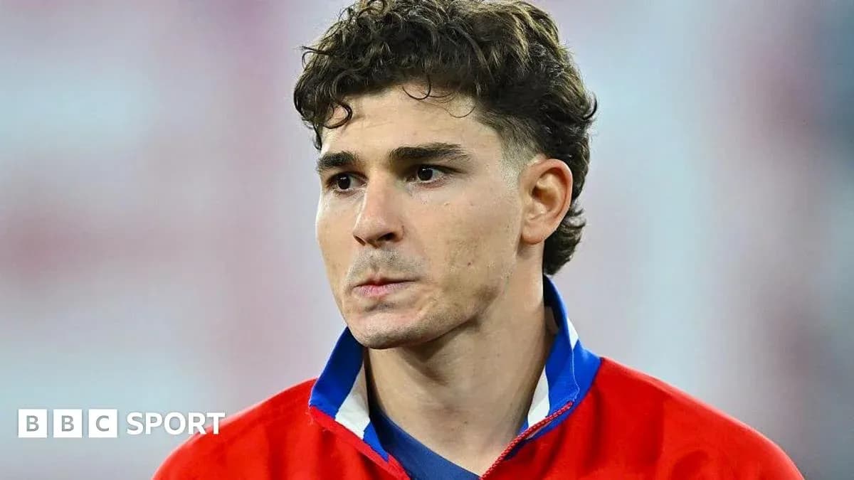Player in red jersey looking serious on field