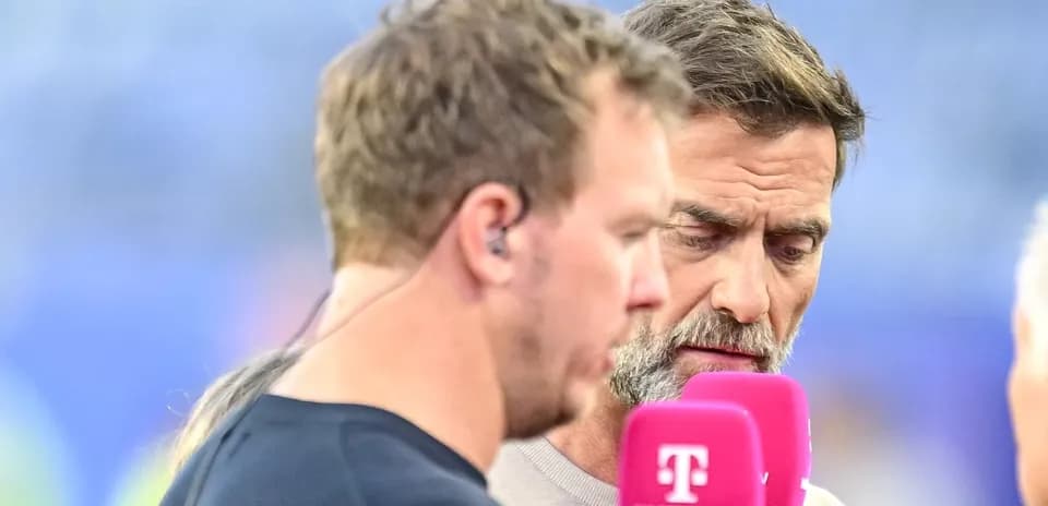 Two commentators speaking into microphones during broadcast