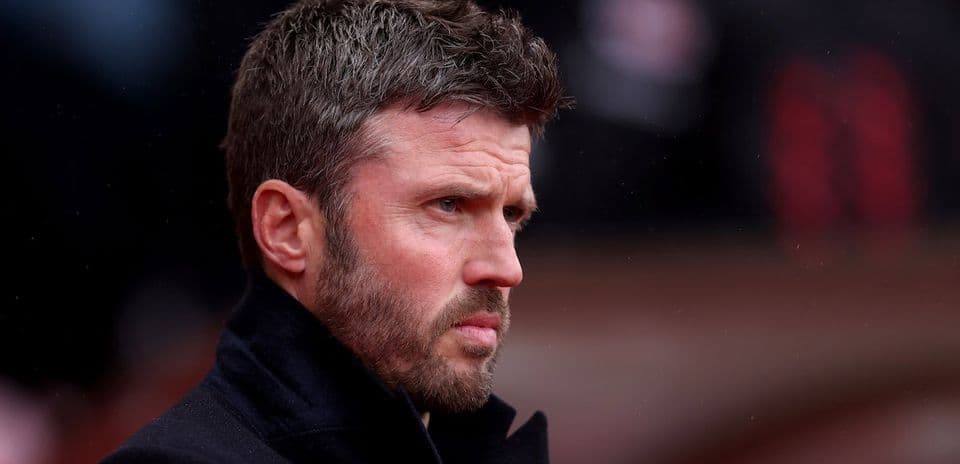 Man with short hair and beard looking pensively