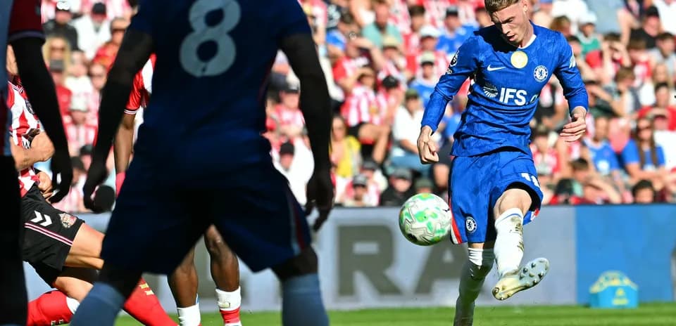 Chelsea player taking a shot during match
