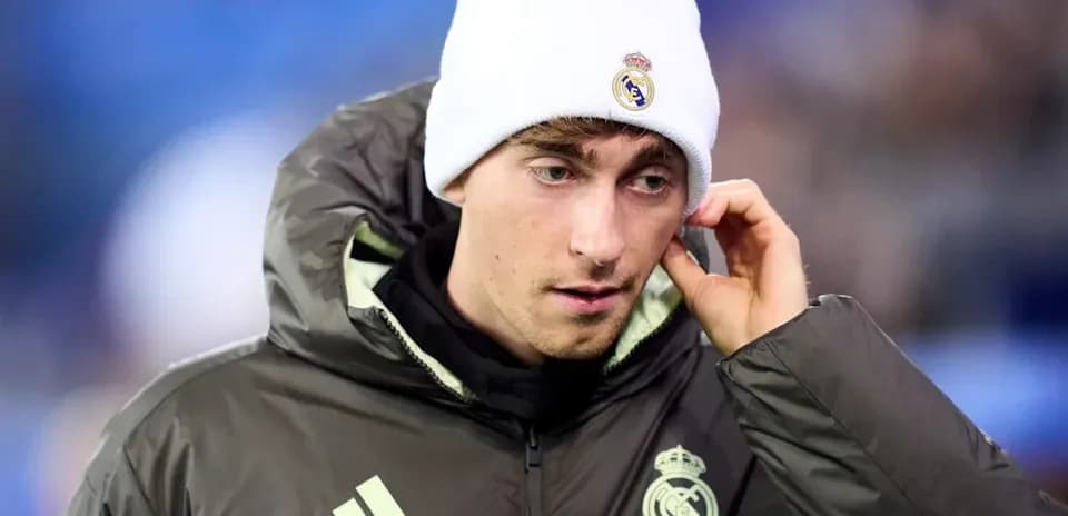Player in Real Madrid jacket and beanie before match