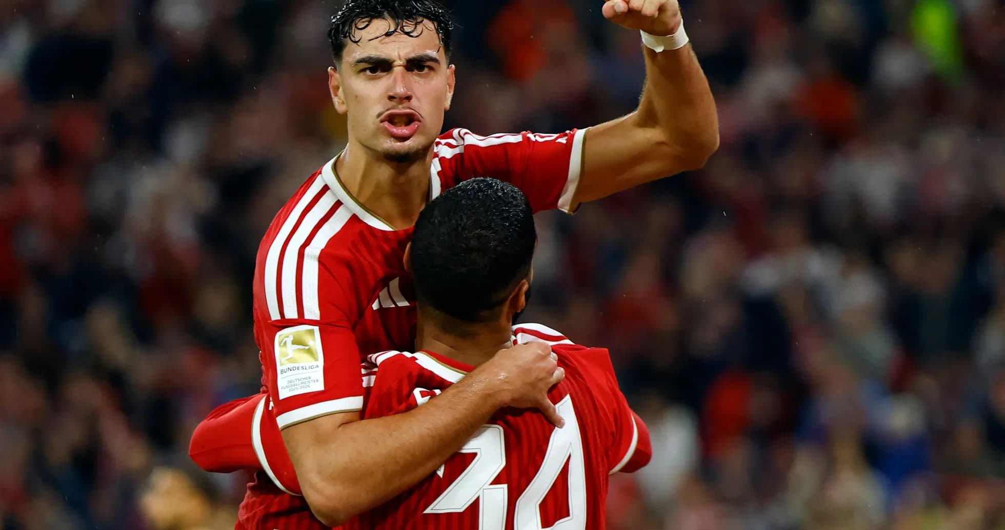 Two players celebrating a goal during a match