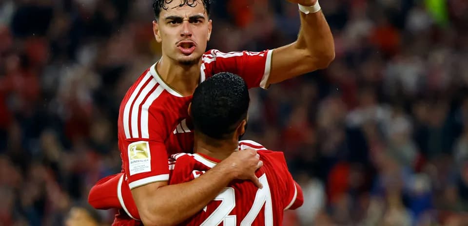 Two players celebrating a goal during a match