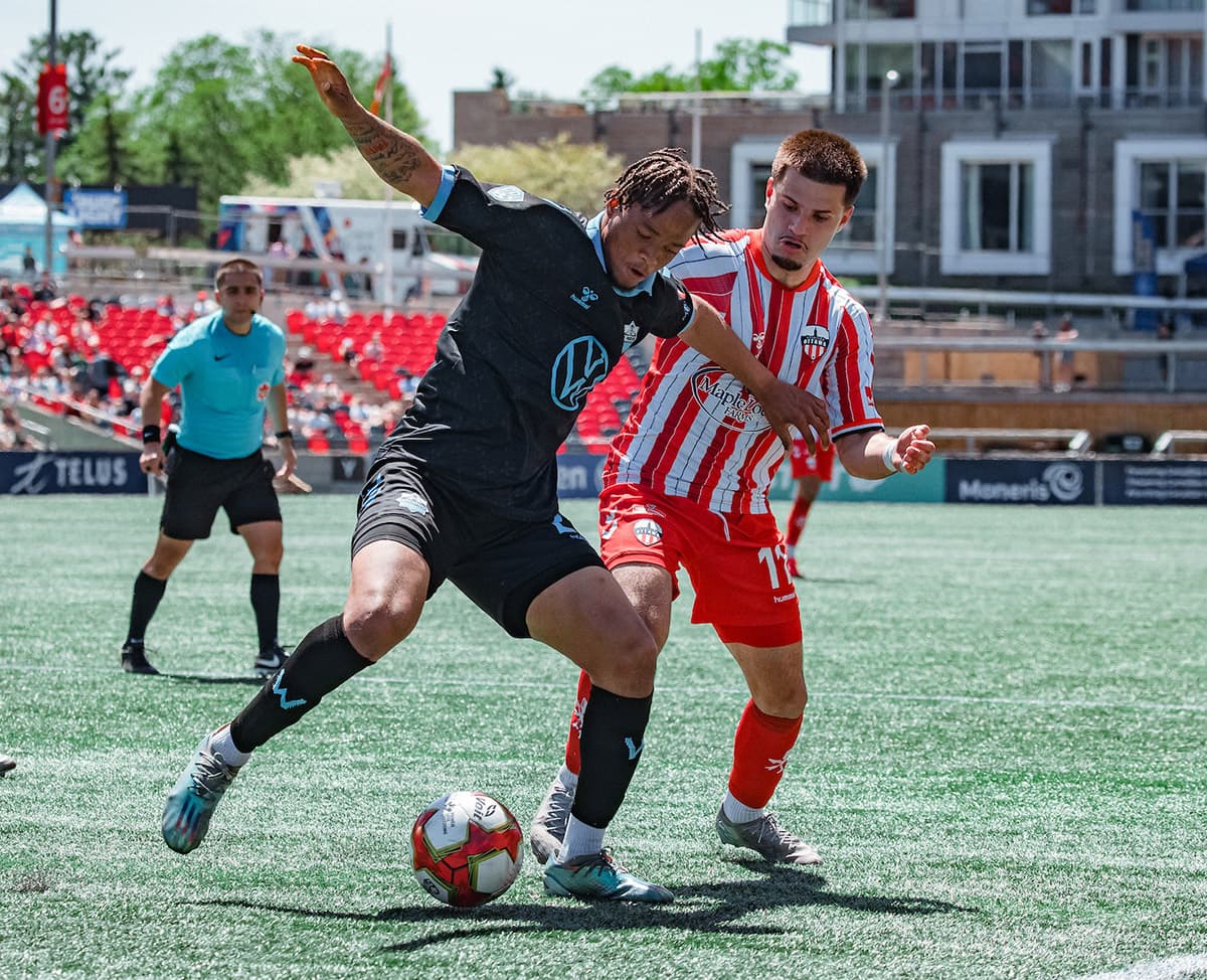 Player tackling during Atlético Ottawa match