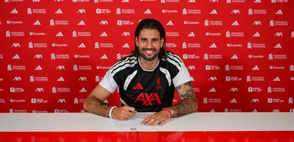 Player signing contract at Liverpool FC press conference