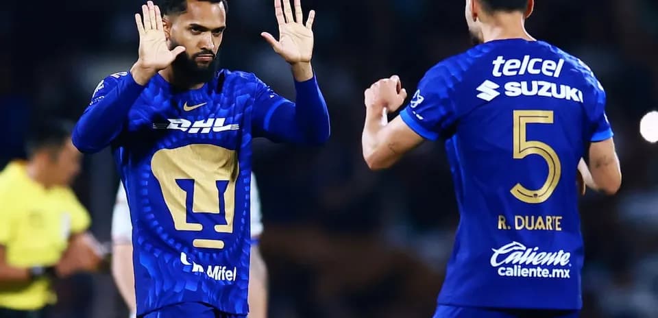 Players celebrating during Liga MX match