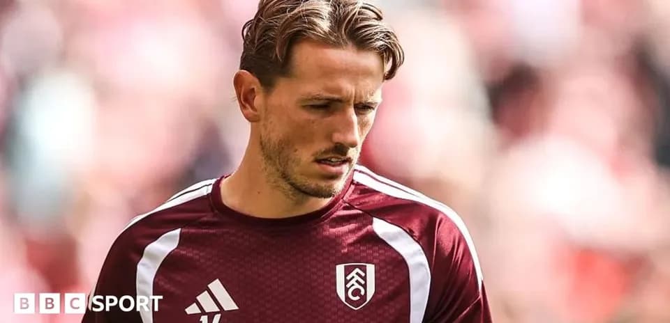 Player wearing maroon training kit before match