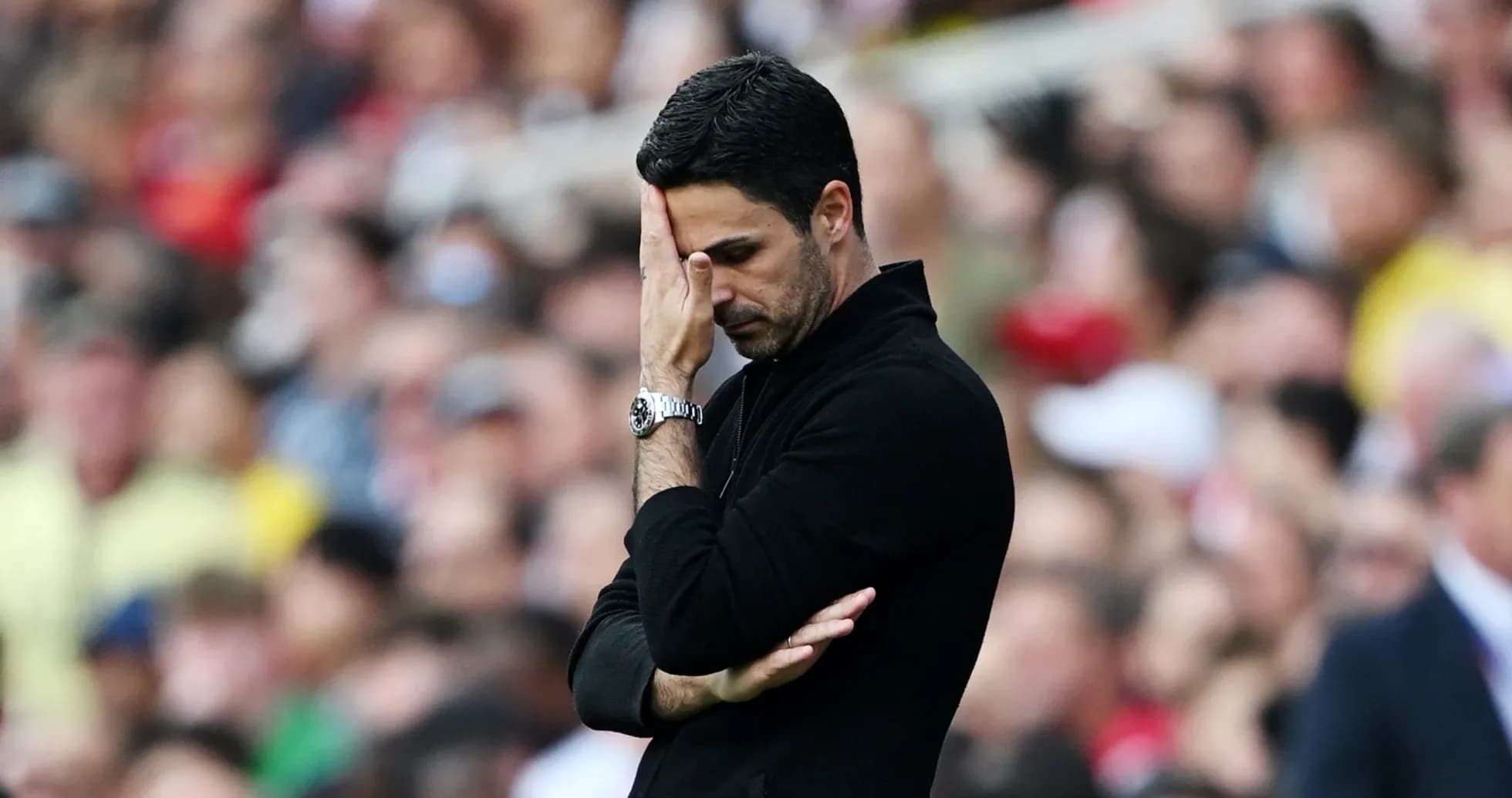 Manager looking concerned during match on sidelines