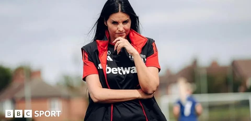 Female coach observing training session on pitch