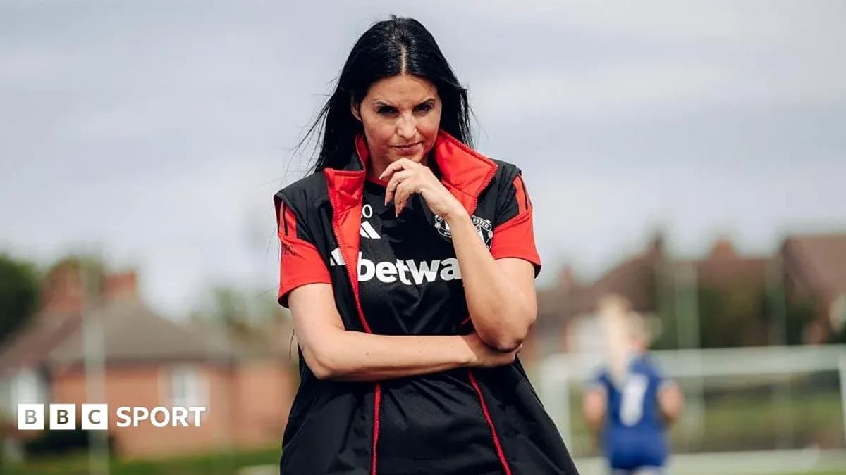 Female coach observing training session on pitch
