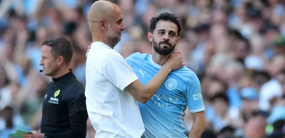 Pep Guardiola embracing Bernardo Silva on field