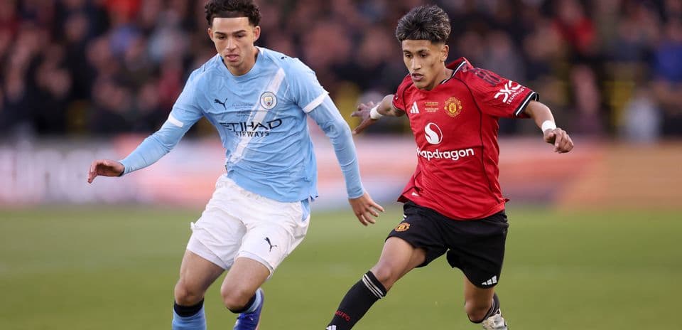 Players from Manchester City and Manchester United competing for the ball