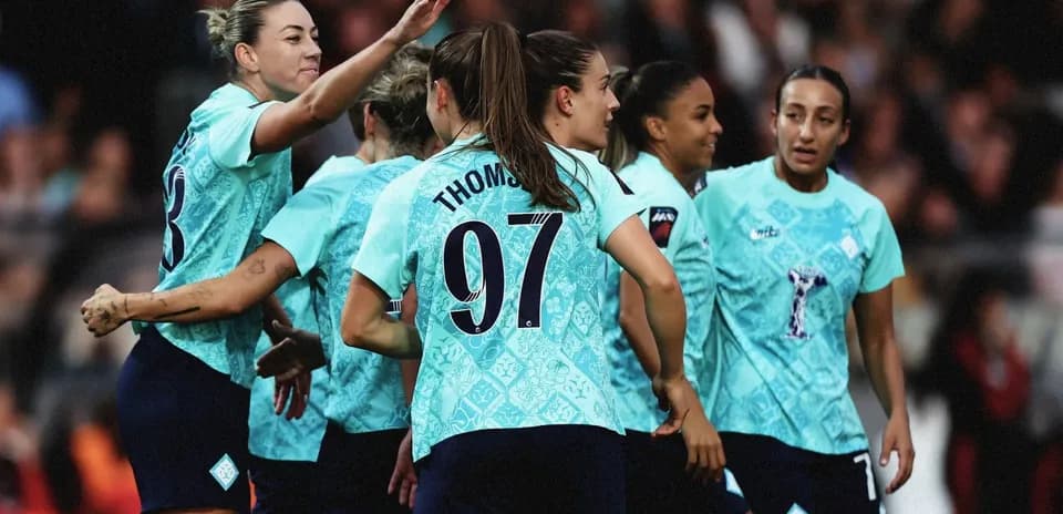 Players celebrating a goal on the field