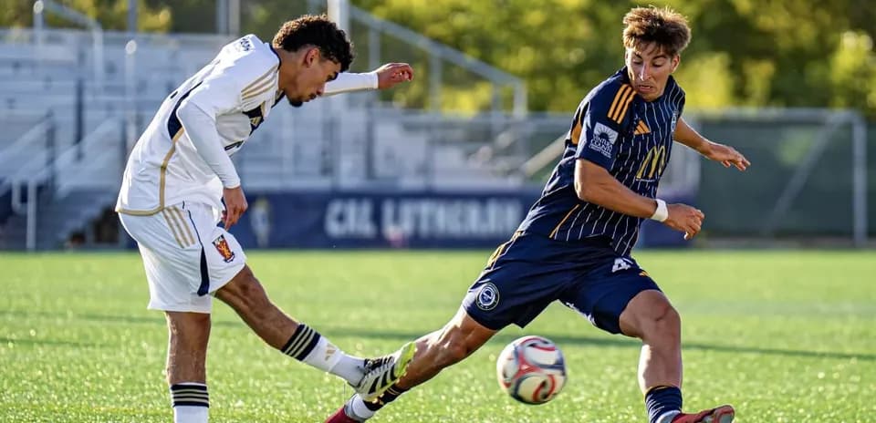 Two players competing for the ball in football