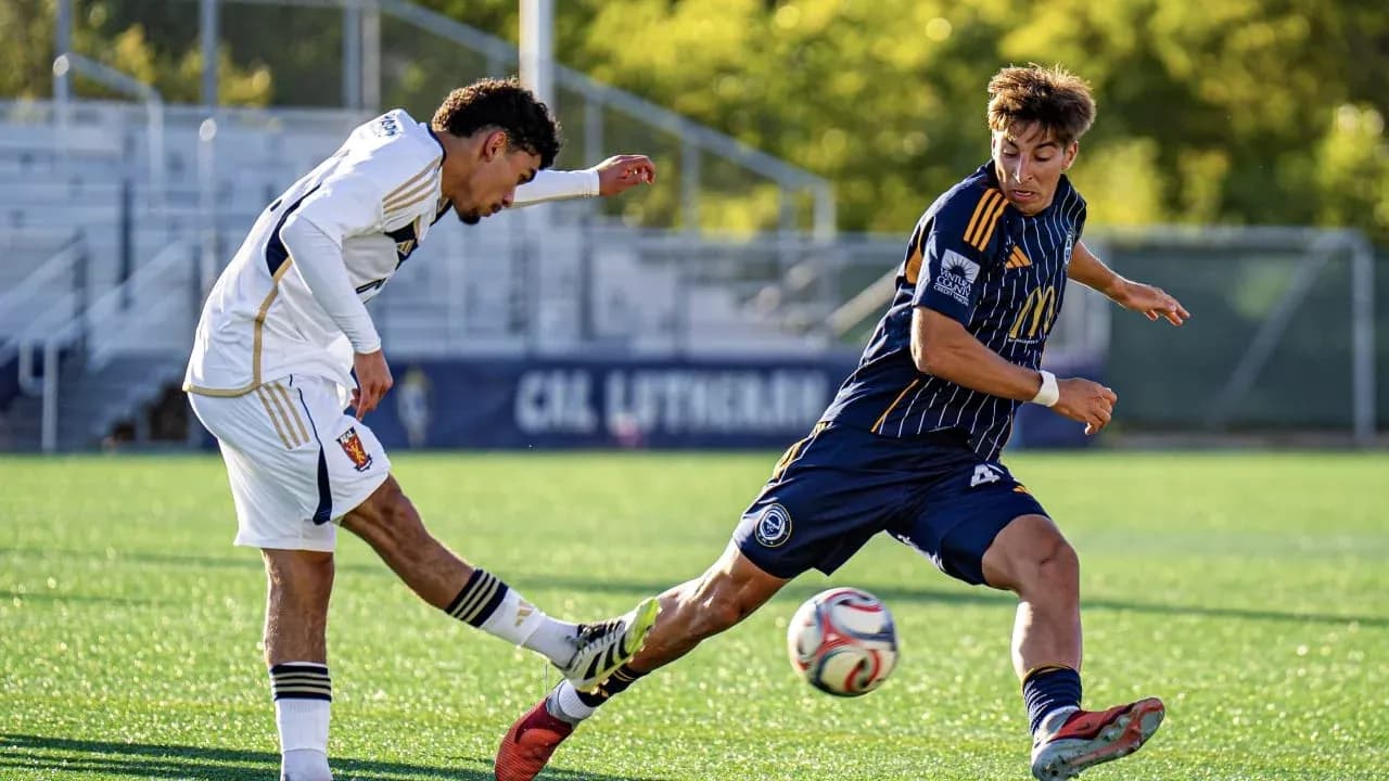Two players competing for the ball in football