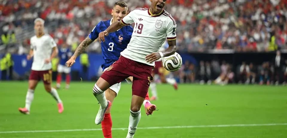 Player from Spain evading tackle by French defender