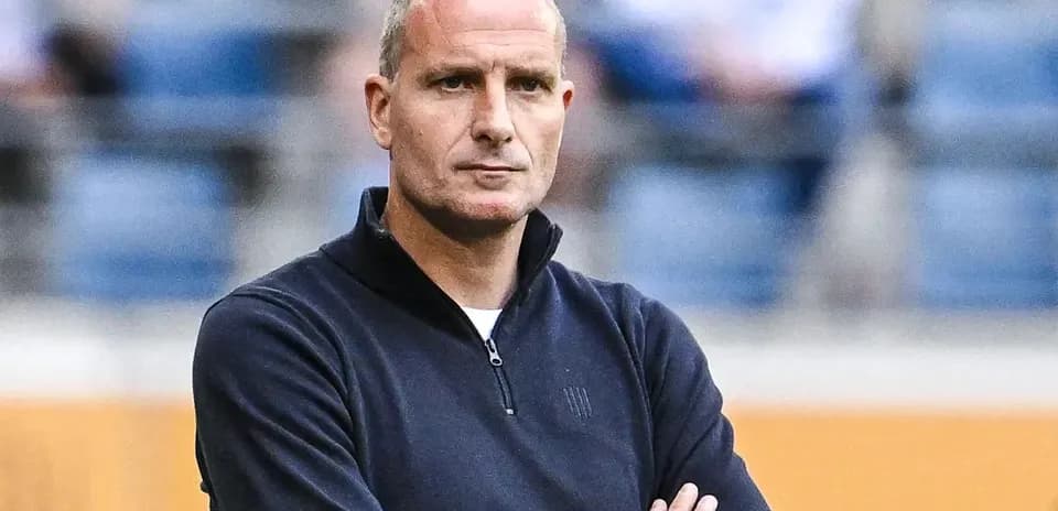 Coach with arms crossed observing the game
