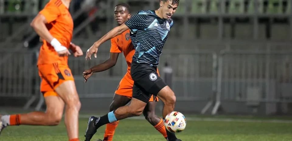 Tacoma Defiance player dribbling against Houston Dynamo FC II