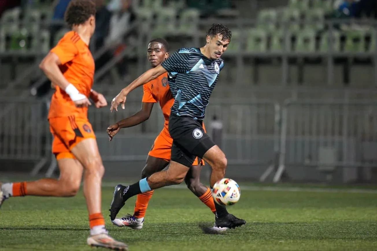 Tacoma Defiance player dribbling against Houston Dynamo FC II Tacoma Defiance player dribbling against Houston Dynamo FC II