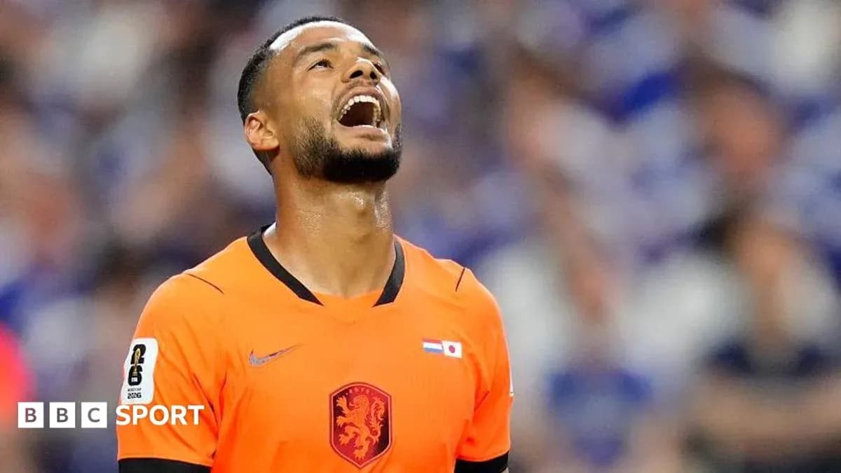 Player in orange kit looking up during match
