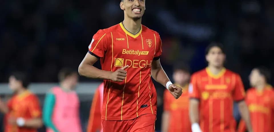 Player celebrating during a match in red jersey