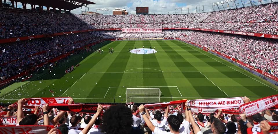 Fans cheering in stadium during Sevilla match