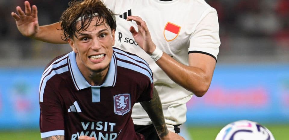 Player from Aston Villa being challenged during match