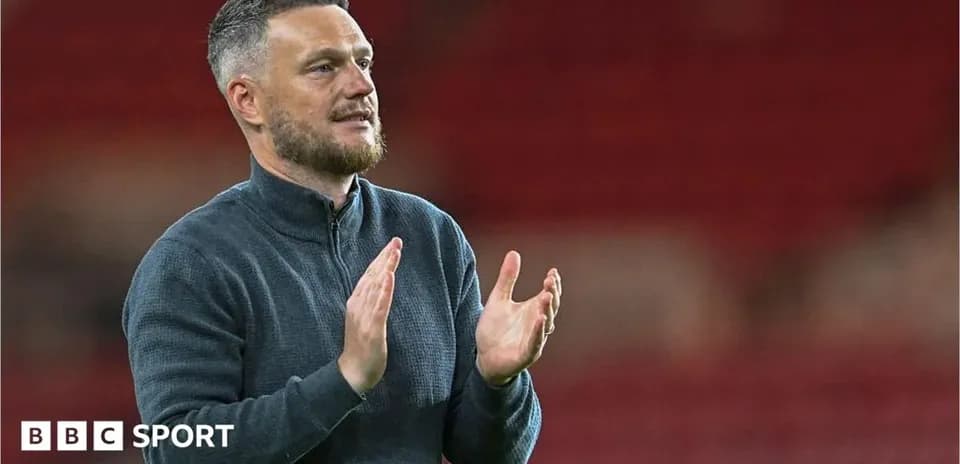 Coach applauding fans after a match
