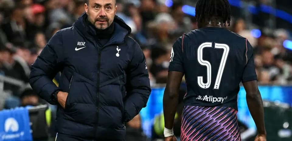 Tottenham coach discussing strategy with player on pitch
